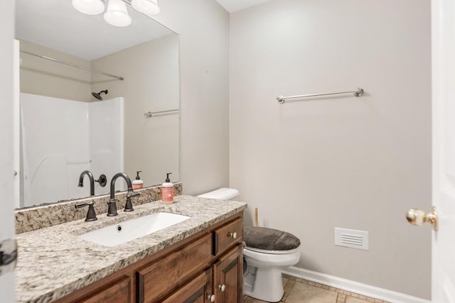 bathroom featuring walk in shower, vanity, toilet, and baseboards