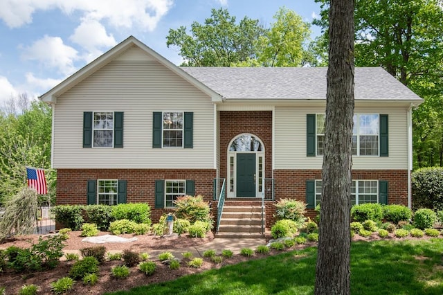 split foyer home featuring brick siding