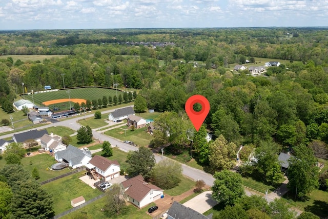 bird's eye view with a wooded view