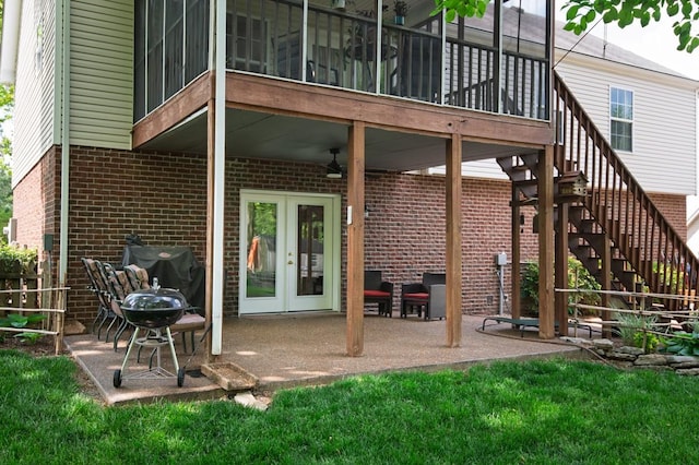 back of property featuring stairway, a patio, a ceiling fan, and brick siding