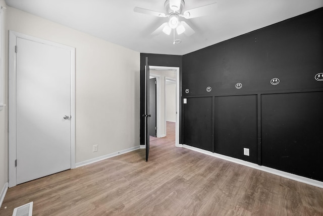 1872 River Rd, Clarksville, TN 37040 - unfurnished bedroom with wood finished floors, baseboards, and a ceiling fan