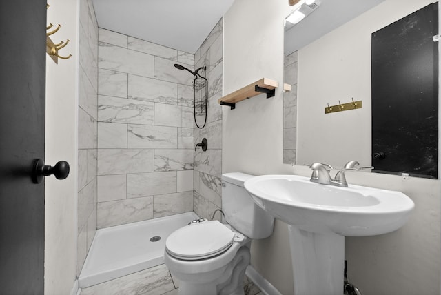 1872 River Rd, Clarksville, TN 37040 - bathroom with marble finish flooring, a stall shower, toilet, and baseboards