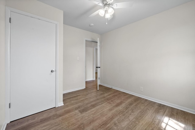 1872 River Rd, Clarksville, TN 37040 - unfurnished bedroom with wood finished floors, baseboards, and a ceiling fan