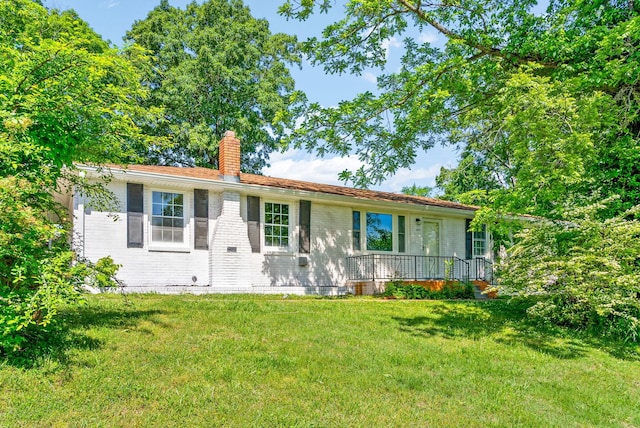 1872 River Rd, Clarksville, TN 37040 - view of front of home featuring a chimney, a front lawn, and brick siding