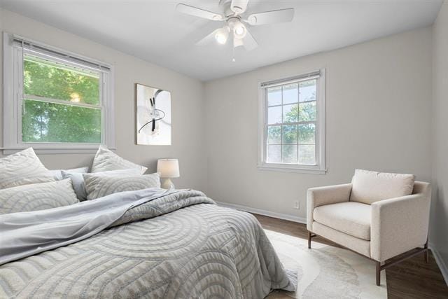 1872 River Rd, Clarksville, TN 37040 - bedroom with multiple windows, wood finished floors, baseboards, and a ceiling fan