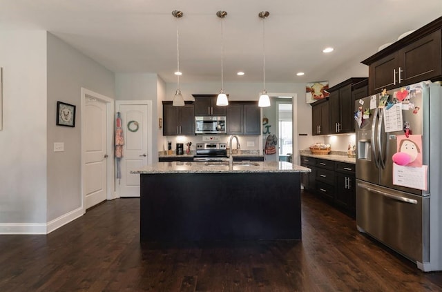 kitchen with a sink, dark wood-type flooring, light stone countertops, baseboards, and appliances with stainless steel finishes