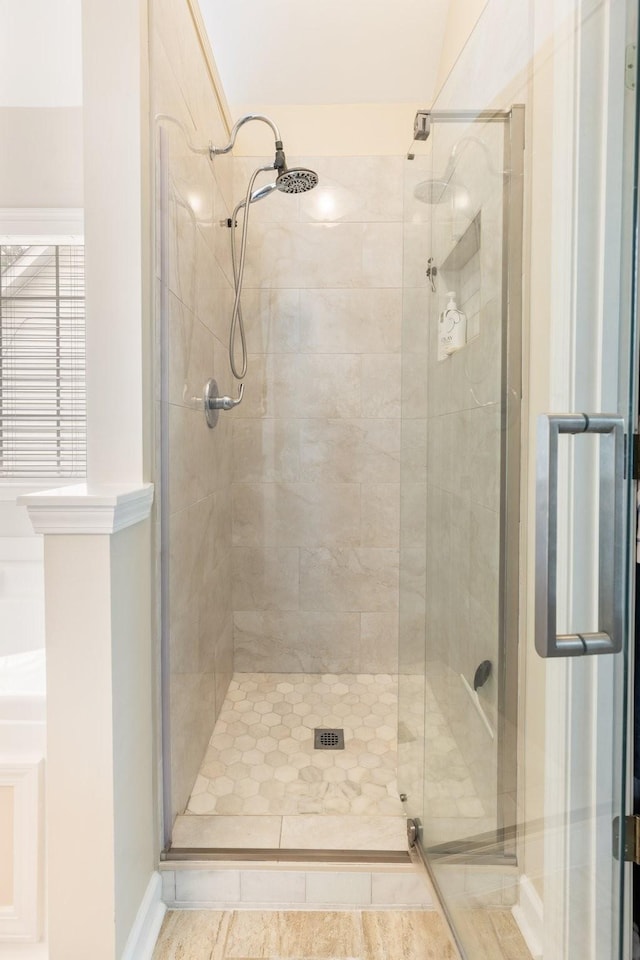 full bath with a stall shower and baseboards