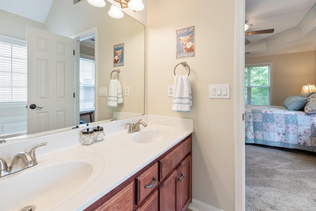 full bathroom with double vanity, a sink, ensuite bathroom, ceiling fan, and ornamental molding