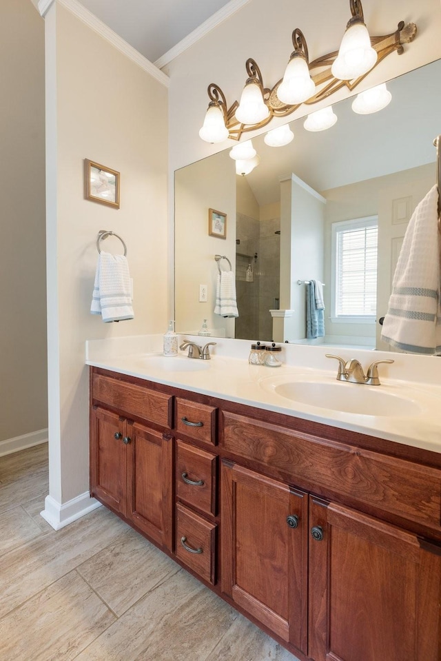 full bathroom featuring ornamental molding, tiled shower, a sink, and double vanity
