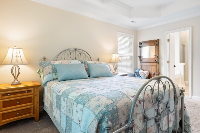 carpeted bedroom with a tray ceiling, crown molding, ensuite bath, and visible vents