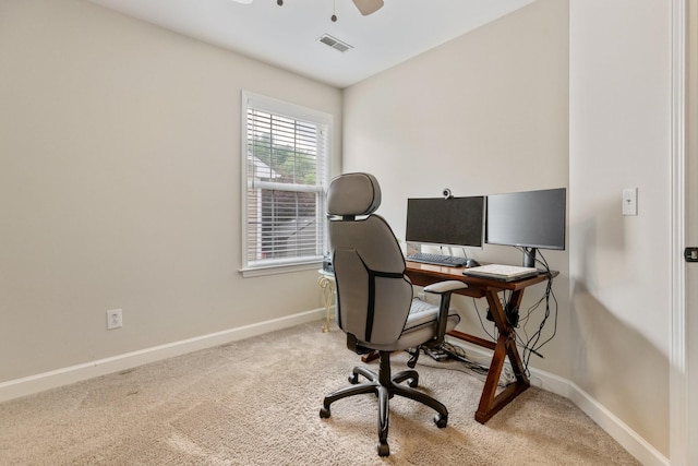 carpeted home office featuring baseboards, visible vents, and a ceiling fan