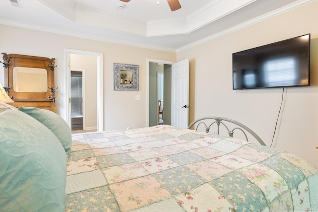 bedroom with a tray ceiling, ceiling fan, and ornamental molding