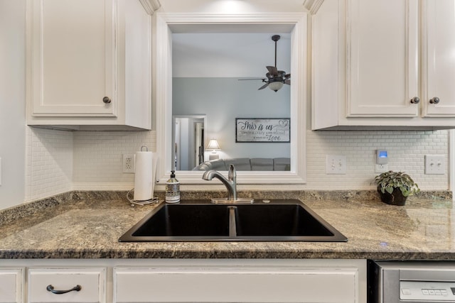 kitchen featuring white cabinets, tasteful backsplash, ceiling fan, and a sink