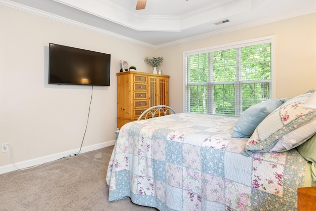 carpeted bedroom with visible vents, crown molding, a ceiling fan, a raised ceiling, and baseboards