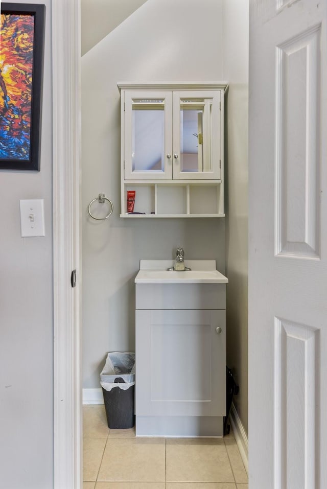 bathroom featuring tile patterned floors, baseboards, and vanity