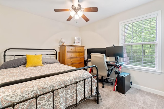 carpeted bedroom featuring baseboards, a ceiling fan, and multiple windows
