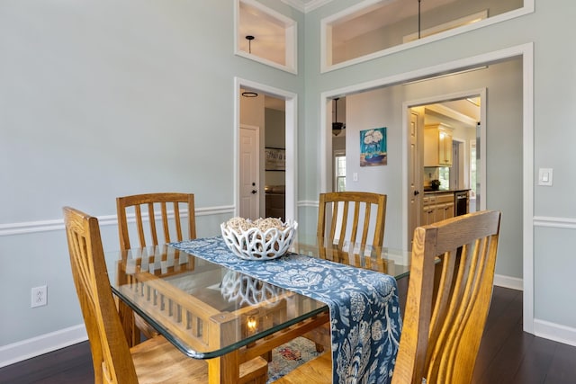 dining room featuring baseboards and dark wood-style floors