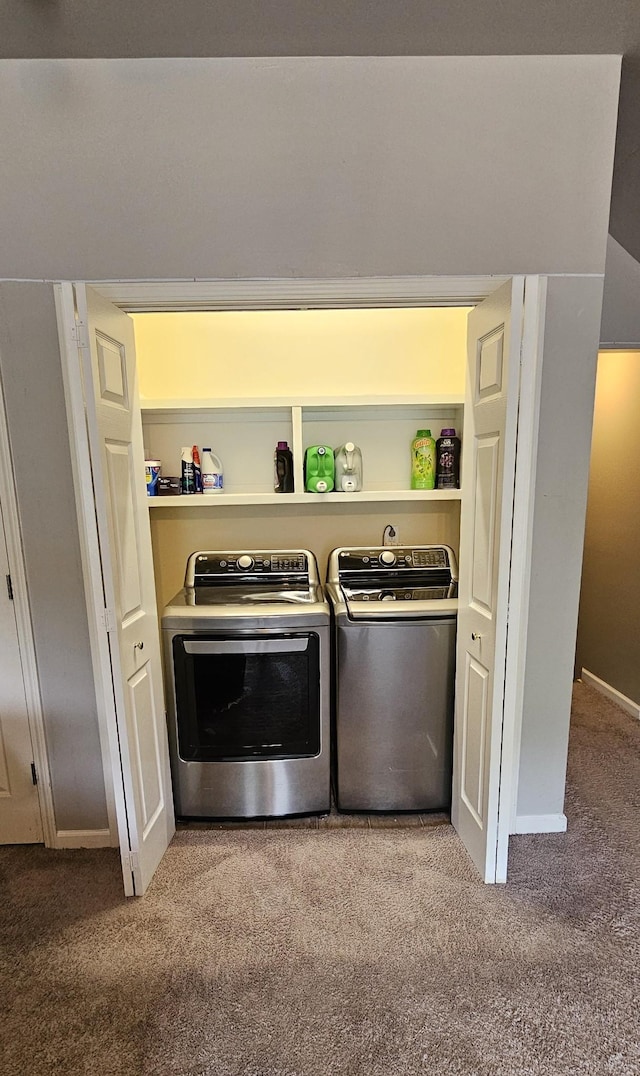 laundry area featuring washing machine and dryer, laundry area, carpet, and baseboards