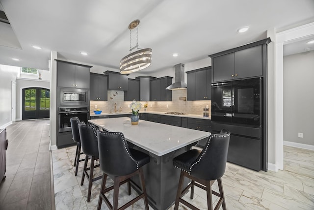 601 Joyce Ave, Lewisburg, TN 37091 - kitchen featuring baseboards, decorative backsplash, a kitchen island, wall chimney range hood, and stainless steel appliances