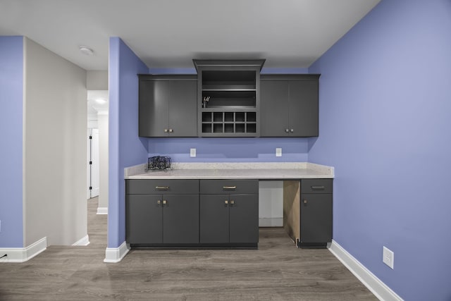 601 Joyce Ave, Lewisburg, TN 37091 - kitchen featuring baseboards, open shelves, gray cabinetry, and wood finished floors
