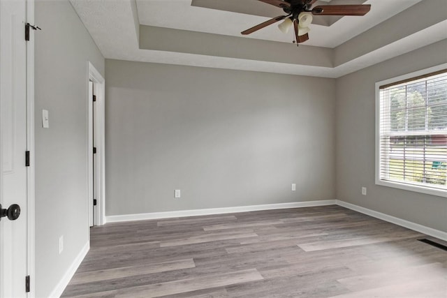 125 Southview Dr, Lewisburg, TN 37091 - empty room featuring a raised ceiling, ceiling fan, and wood finished floors