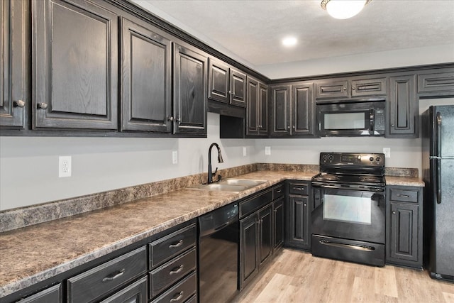 125 Southview Dr, Lewisburg, TN 37091 - kitchen with a sink, dark countertops, black appliances, and light wood-style floors