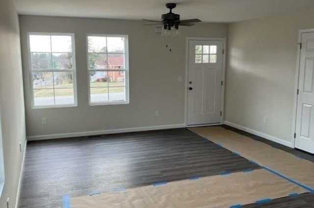 foyer with baseboards, a ceiling fan, and wood finished floors