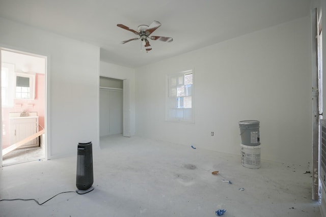 unfurnished bedroom featuring a closet, ensuite bath, and ceiling fan