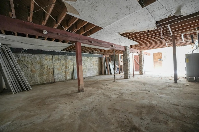 unfinished basement featuring water heater