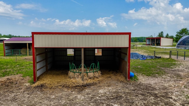 view of pole building with a carport and an exterior structure