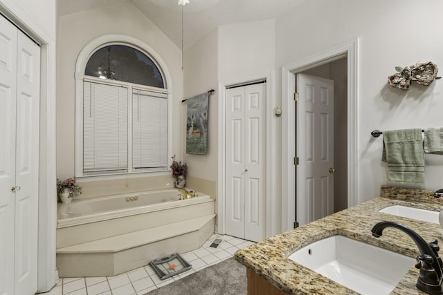 746 Shadow Ln, Belvidere, TN 37306 - full bathroom featuring a closet, a garden tub, tile patterned floors, vaulted ceiling, and double vanity