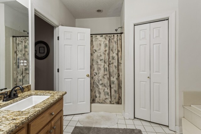 746 Shadow Ln, Belvidere, TN 37306 - bathroom with curtained shower, vanity, tile patterned floors, a textured ceiling, and a closet