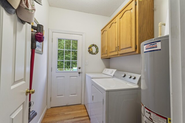 746 Shadow Ln, Belvidere, TN 37306 - laundry room with cabinet space, water heater, washer and dryer, light wood-style flooring, and a textured ceiling