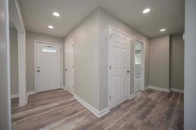 foyer featuring recessed lighting, baseboards, and wood finished floors