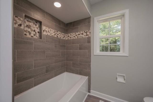 full bathroom featuring toilet, baseboards, and wood finished floors