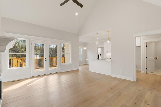119 Casey St, Brush Creek, TN 38547 - unfurnished living room with french doors, light wood-style flooring, high vaulted ceiling, baseboards, and ceiling fan