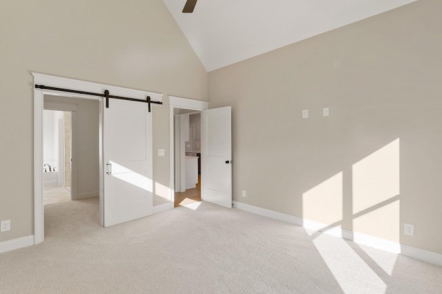 119 Casey St, Brush Creek, TN 38547 - unfurnished bedroom featuring a barn door, high vaulted ceiling, ceiling fan, light carpet, and baseboards