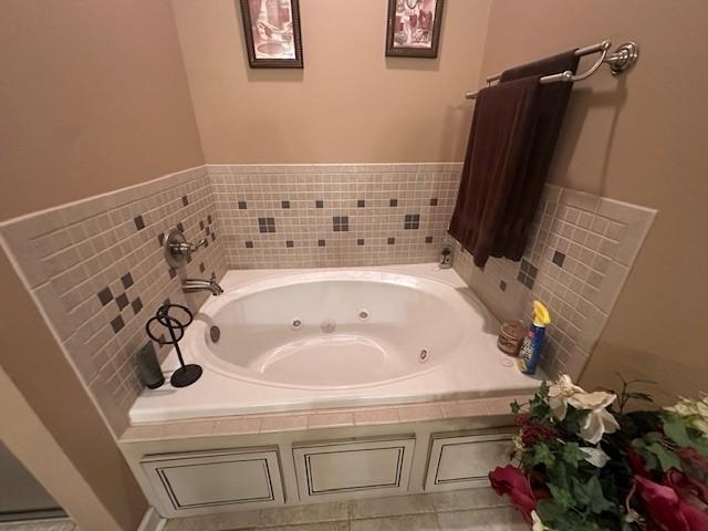 full bath with a whirlpool tub