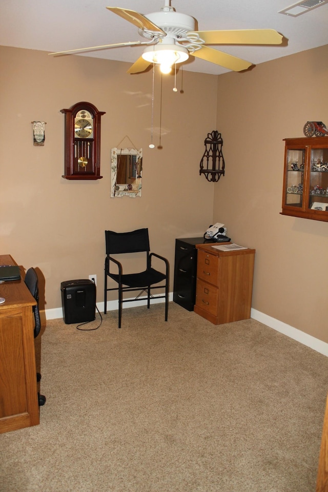 living area featuring a ceiling fan, baseboards, visible vents, and carpet floors