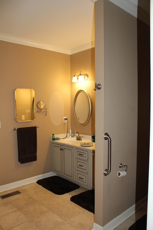 bathroom featuring baseboards, ornamental molding, visible vents, tile patterned floors, and vanity