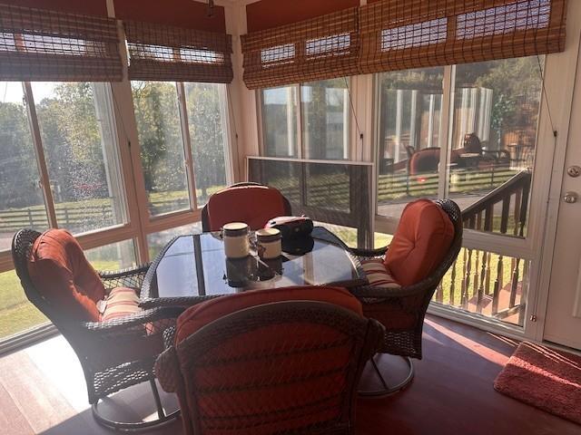 sunroom / solarium featuring wood finished floors