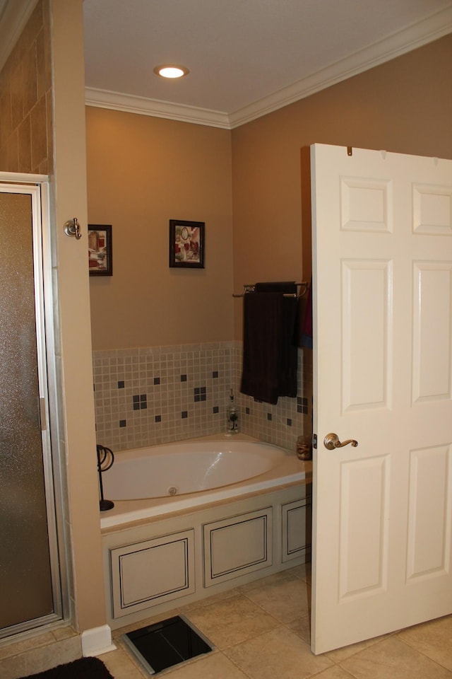 bathroom featuring a stall shower, tile patterned floors, a garden tub, and crown molding