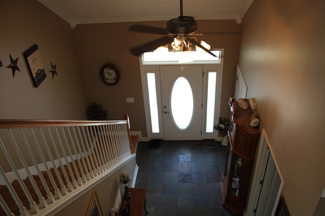 foyer with a ceiling fan, baseboards, stone finish flooring, and crown molding