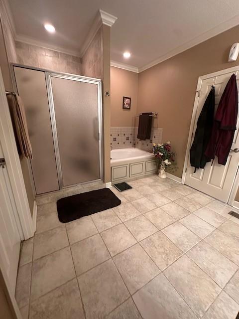 full bathroom with recessed lighting, tile patterned floors, crown molding, a shower stall, and a garden tub