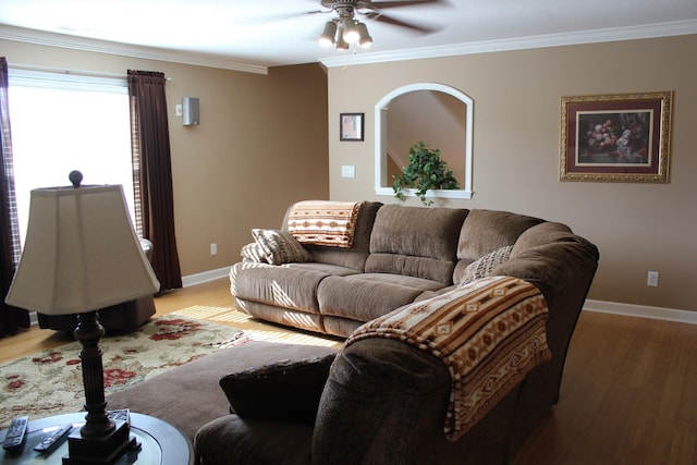 living room with ceiling fan, light wood-style flooring, baseboards, and ornamental molding