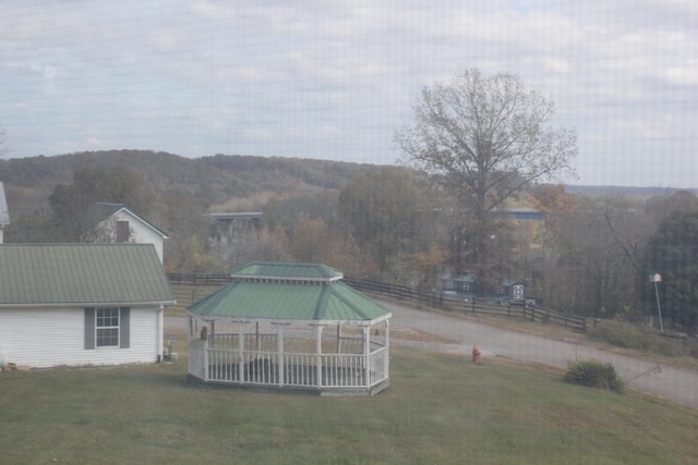 view of yard with a gazebo, a mountain view, and fence