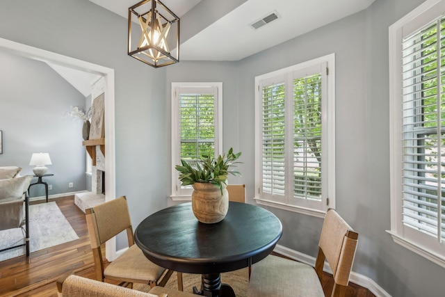 dining area featuring plenty of natural light, visible vents, and wood finished floors