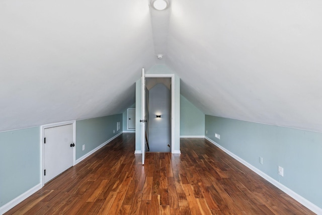 bonus room with vaulted ceiling, baseboards, and wood finished floors