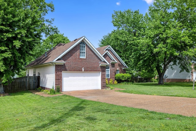 traditional-style house featuring brick siding, fence, a garage, concrete driveway, and a front yard
