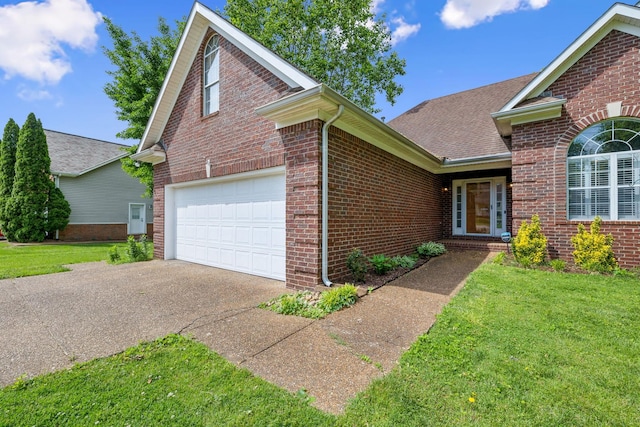 ranch-style house featuring aphalt driveway, a shingled roof, brick siding, and a front yard